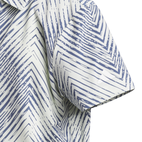 Close up of the sleeve showing the herringbone detail and design of this Adidas Boys golf polo shirt.